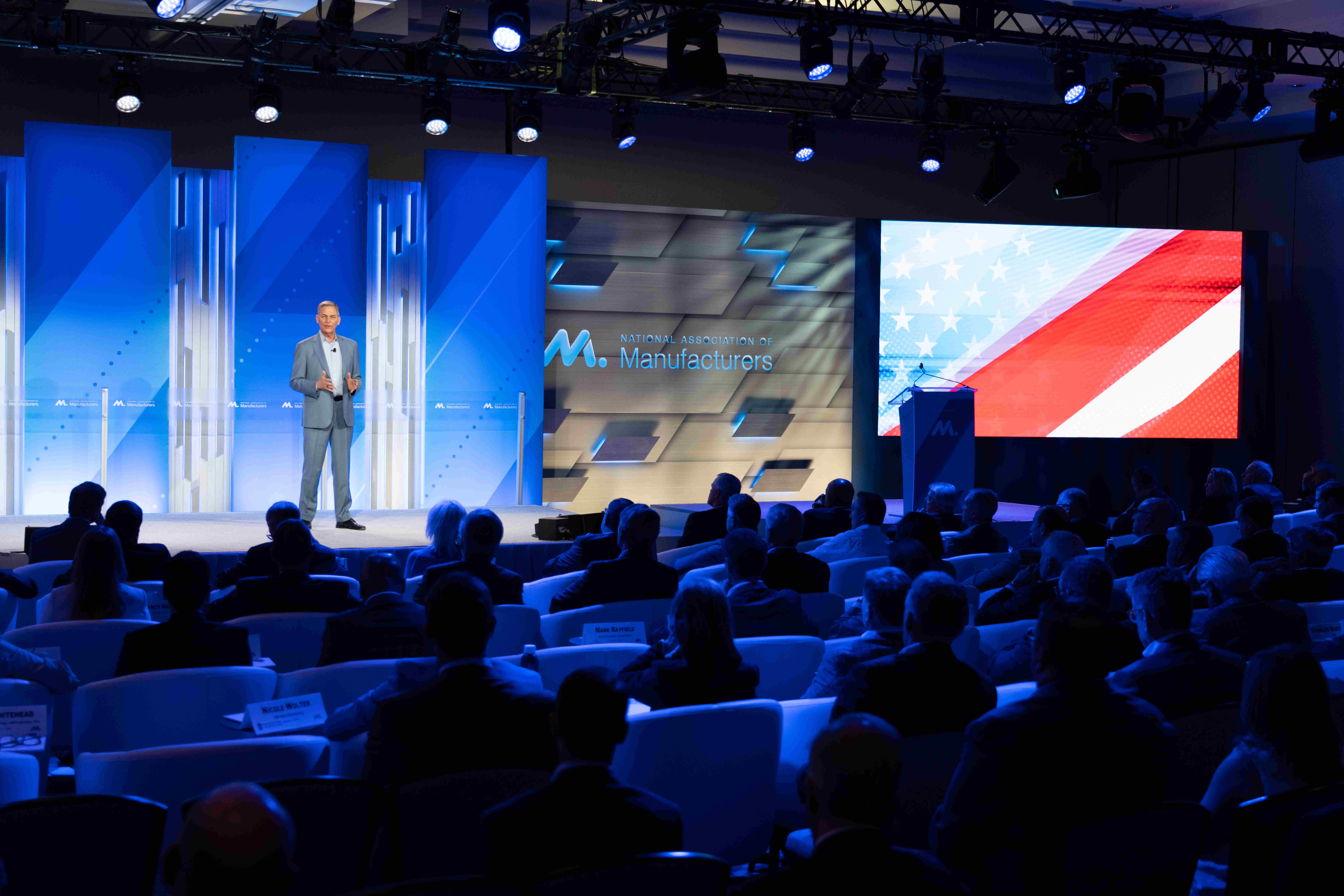 a group of people sitting at a table in front of a crowd